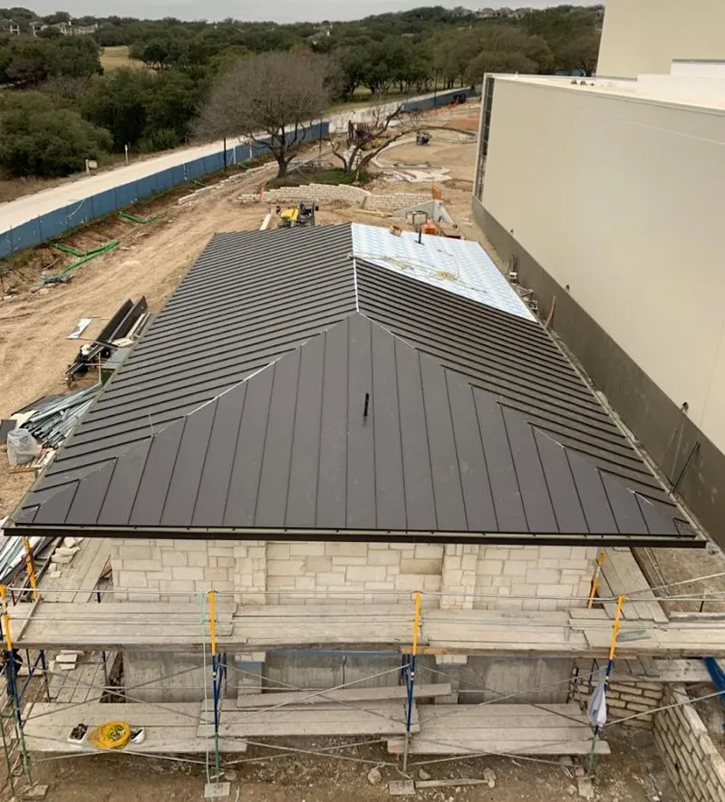 Metal roof new construction with scaffolding in Hudson